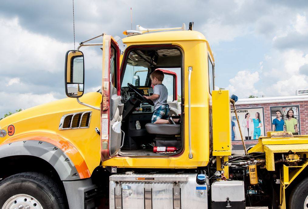 boy in big rig at touch a truck event
