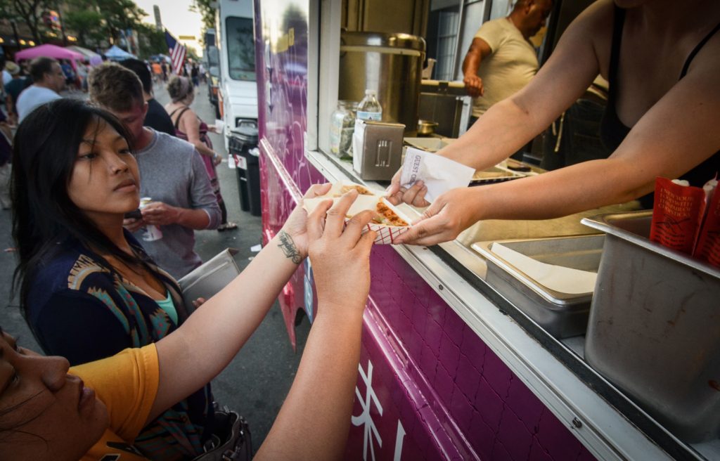 people getting food from a food truck