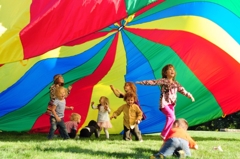 children playing under parachute