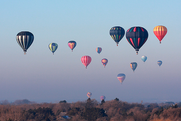 Hudson Hot Air Balloon Festival balloons in the air.