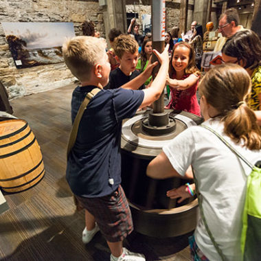 children engaging with a museum exhibit.