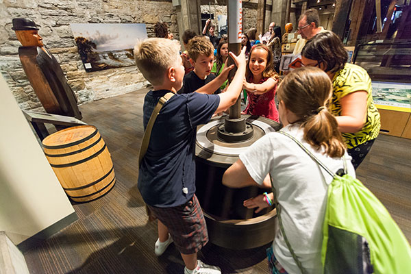 children engaging with a museum exhibit.