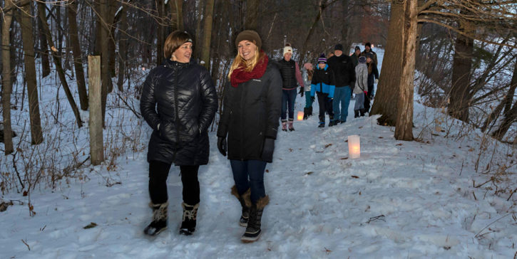 People hiking on snowy trail.