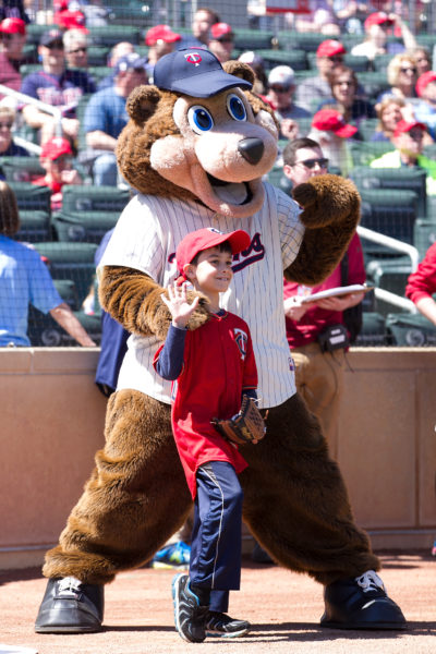 boy with T.C. Bear at Minnesota Twins game.