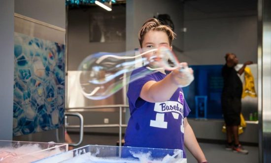 Boy playing with soap bubbles at Minnesota Children's Museum.