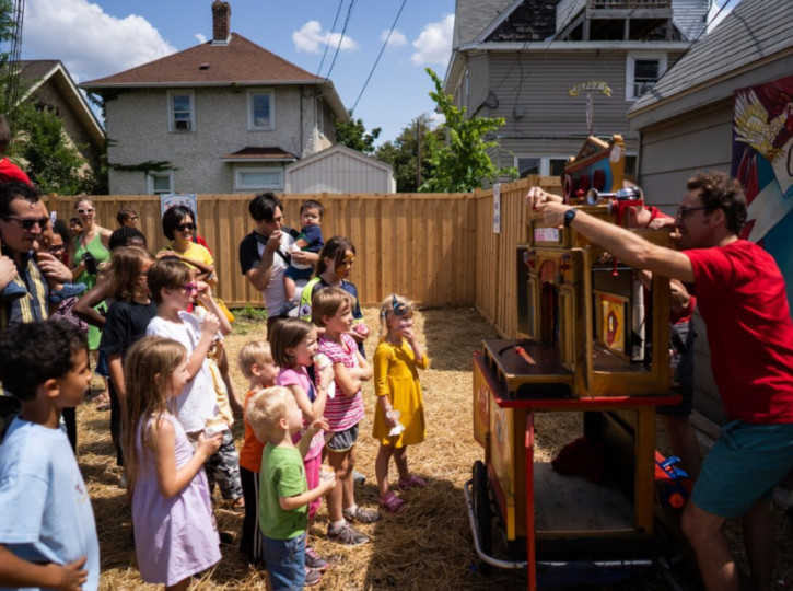 group of children watching a puppet show