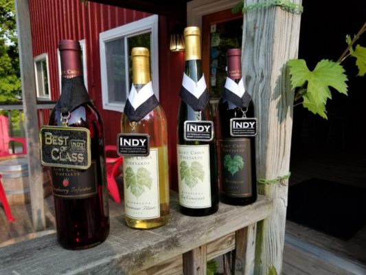 four wine bottles on a ledge