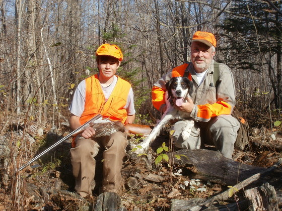 man and boy hunting with dog