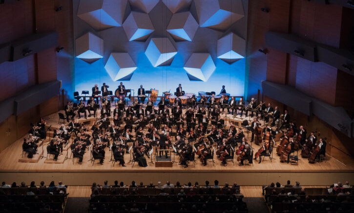 Large symphony orchestra on stage. 