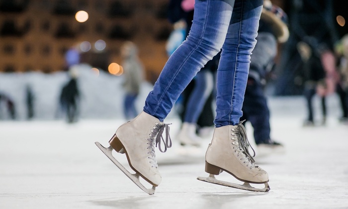 up close image of ice skates on a rink. 