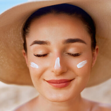 woman wearing sunscreen and hat