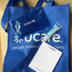 UCare goodie bag with hand sanitizer, hot/cold pack, notepad