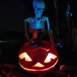 skeleton holding jack-o-lantern