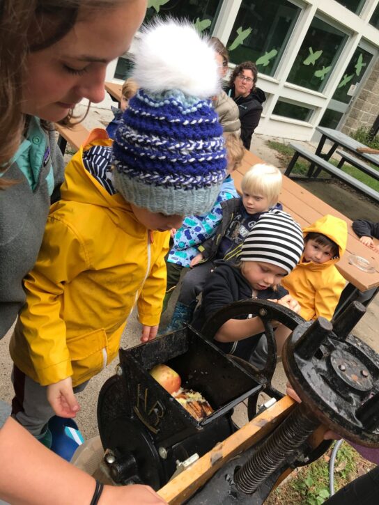 children pressing apples at Wargo Fall Festival.