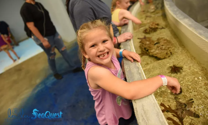 girl playing at SeaQuest