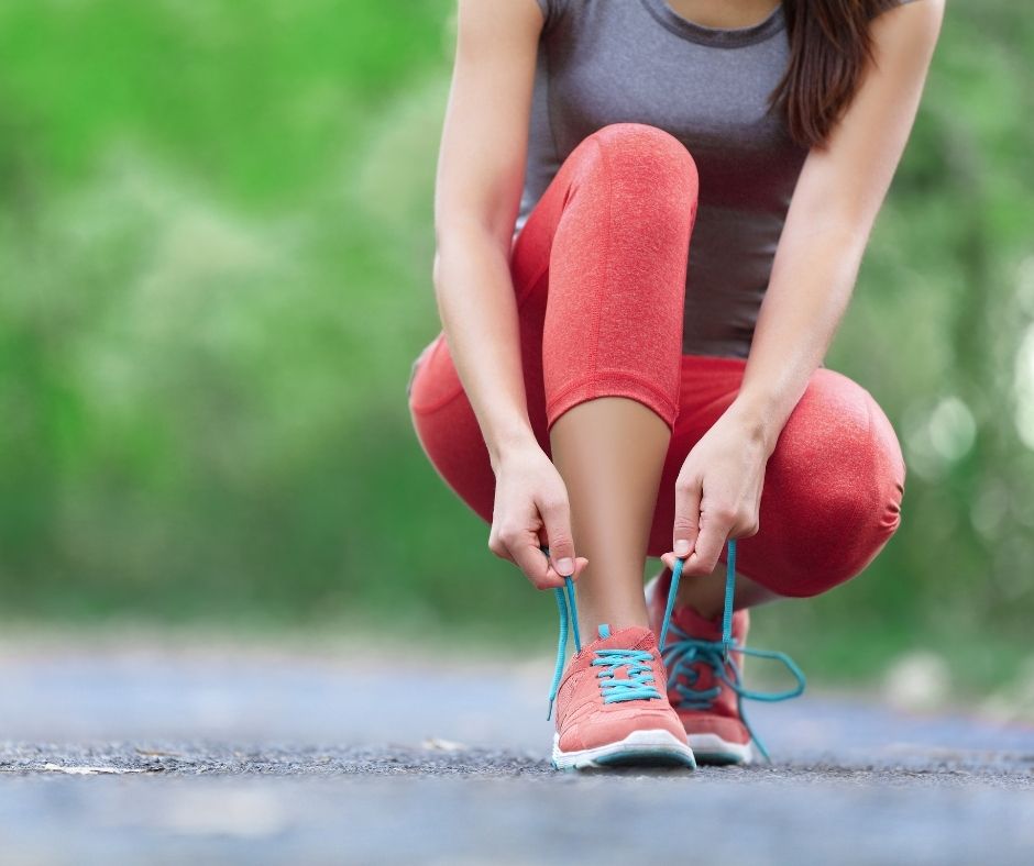 woman lacing running shoes