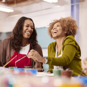 Two women at a painting class together.
