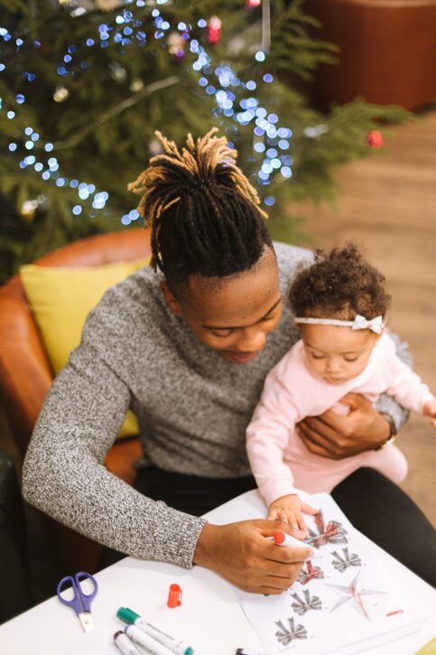 father and daughter working on holiday craft