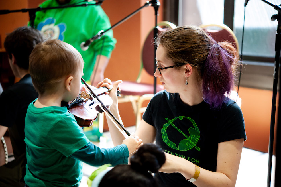 Child playing fiddle at Irish Fair of Minnesota.