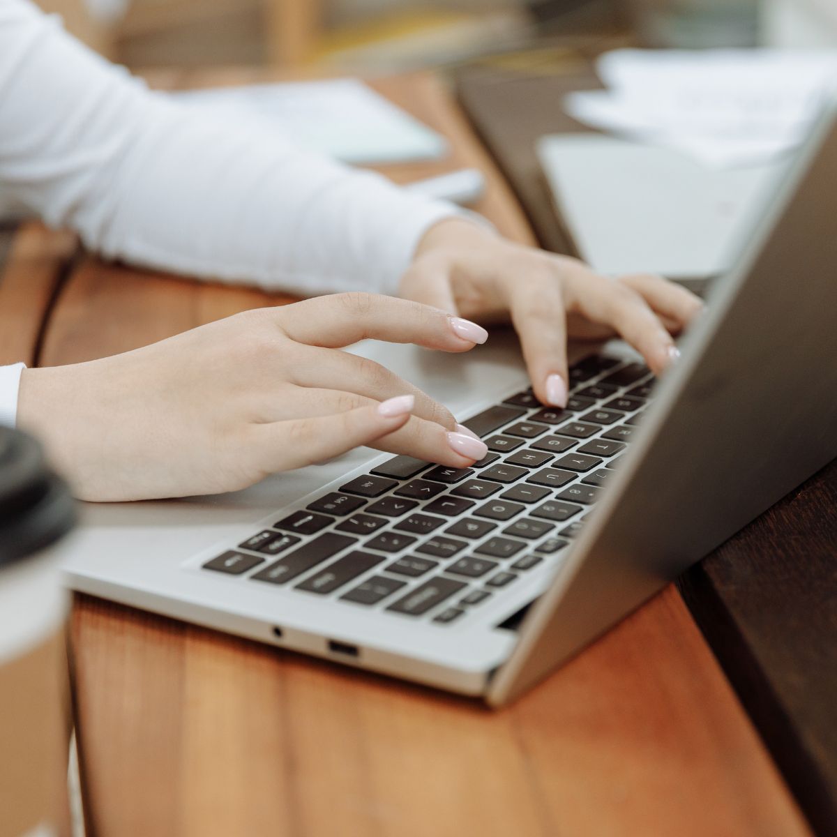 woman typing on macbook