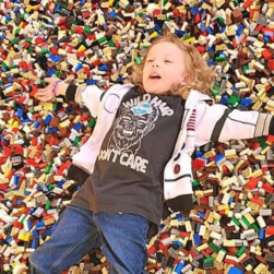 Brick Fest Live Child in pile of Legos