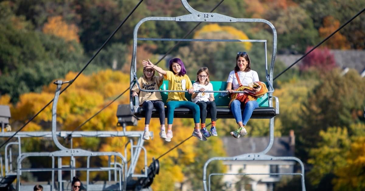 Woman and 3 girls on Highland Hills Fall Chairlift Ride.