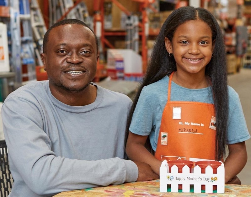 Dad and daughter at Home Depot kids workshop.