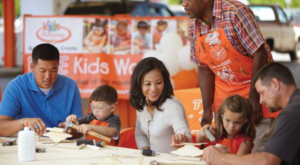Families creating projects together at Home Depot Kids Workshop.