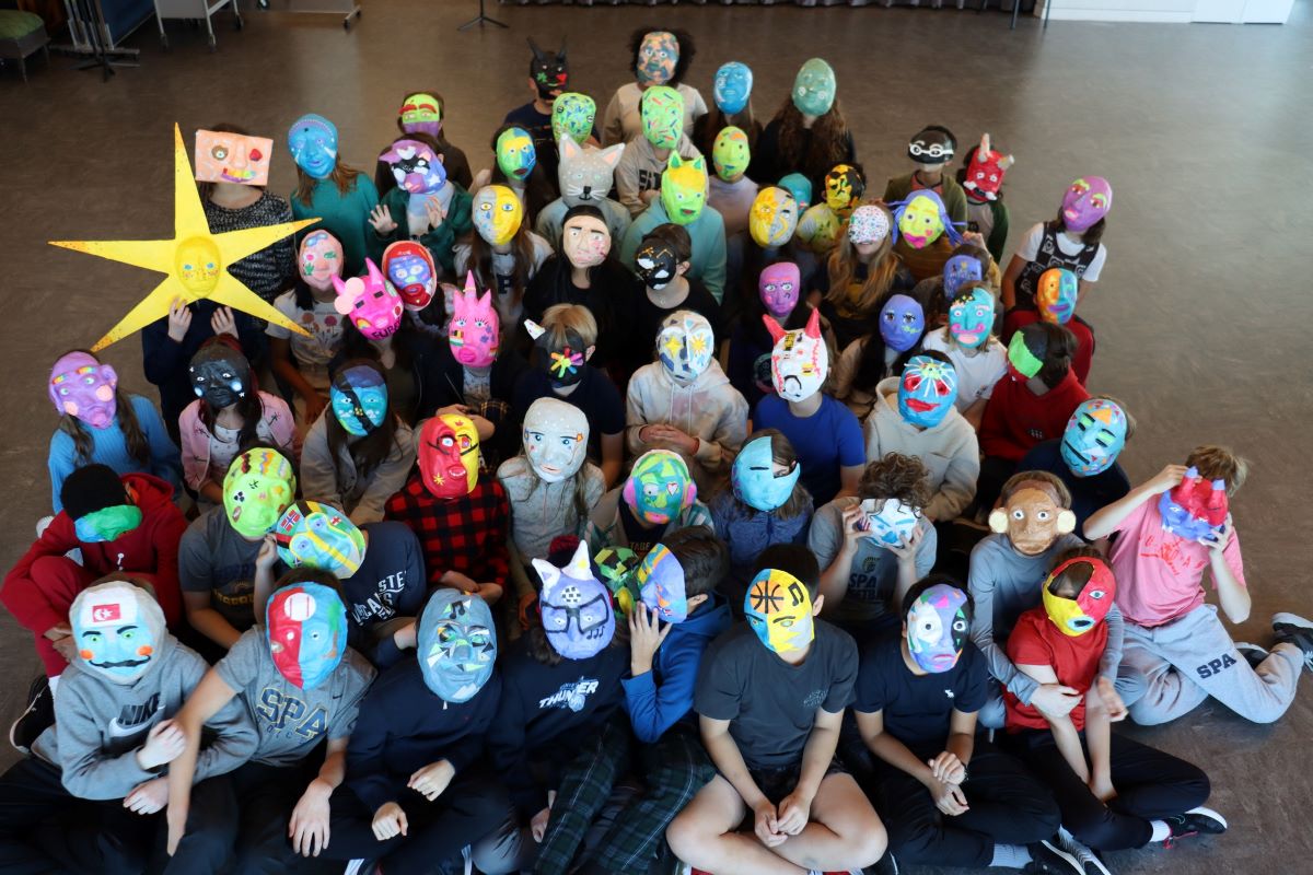 group of children wearing halloween masks at heart of the beast puppet library.
