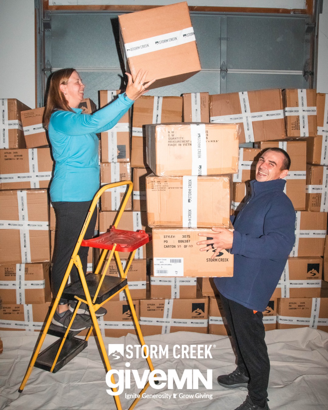 Storm Creek Warehouse sale, two workers stacking boxes. 