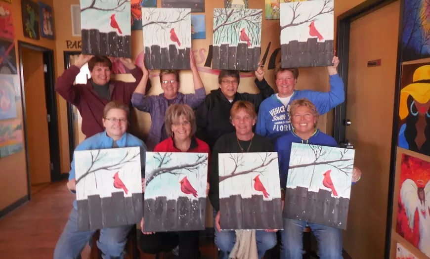 Cheers Pablo painting class holding up their completed artwork.