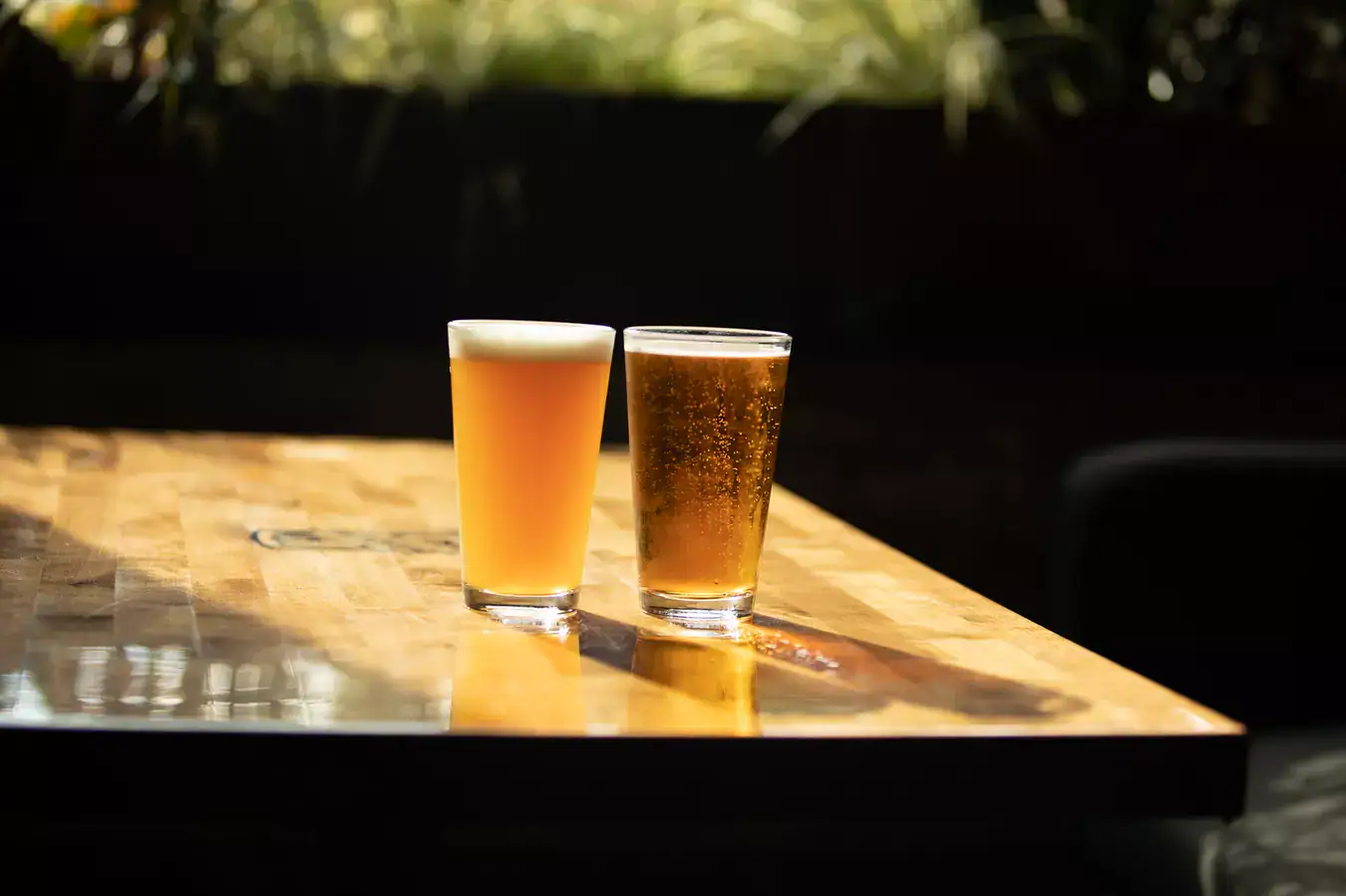 two glasses of craft beer on table.