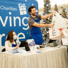 The Giving Tree event at MOA, a woman bringing in a gift to donate.