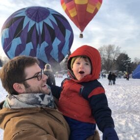 Hudson Hot Affair father and son in front of balloons.