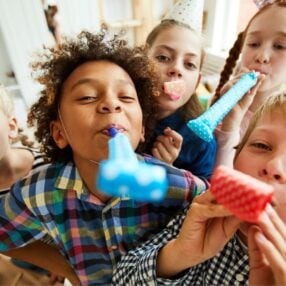 Kids with New Years Eve Noisemakers.