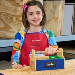 Girl with completed Lowe's Toolbox.