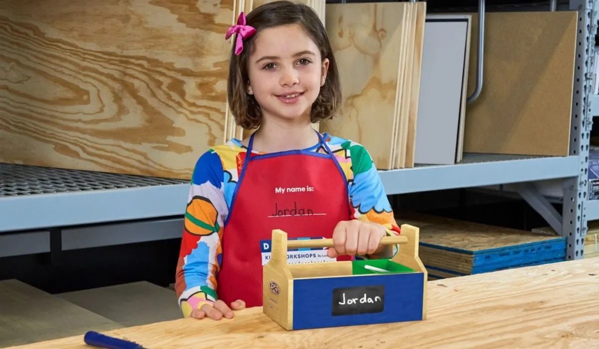 Girl with completed Lowe's Toolbox. 