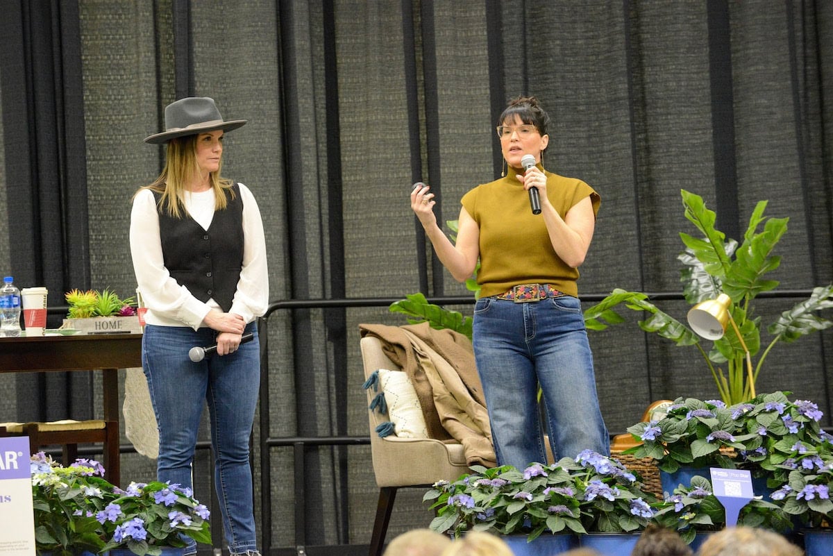 Leslie Davis & Lyndsay Lamb speaking on stage.