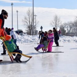 Families and kids sledding on ice at Kids Fest in Minnetonka.