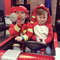 Two children pretending to be firefighters at MN Playseum.