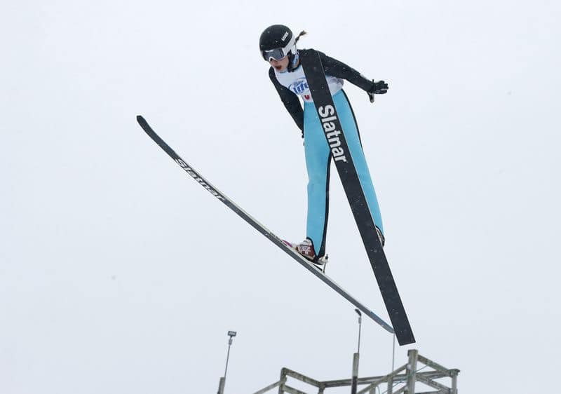 Ski Jumper midair in jump.