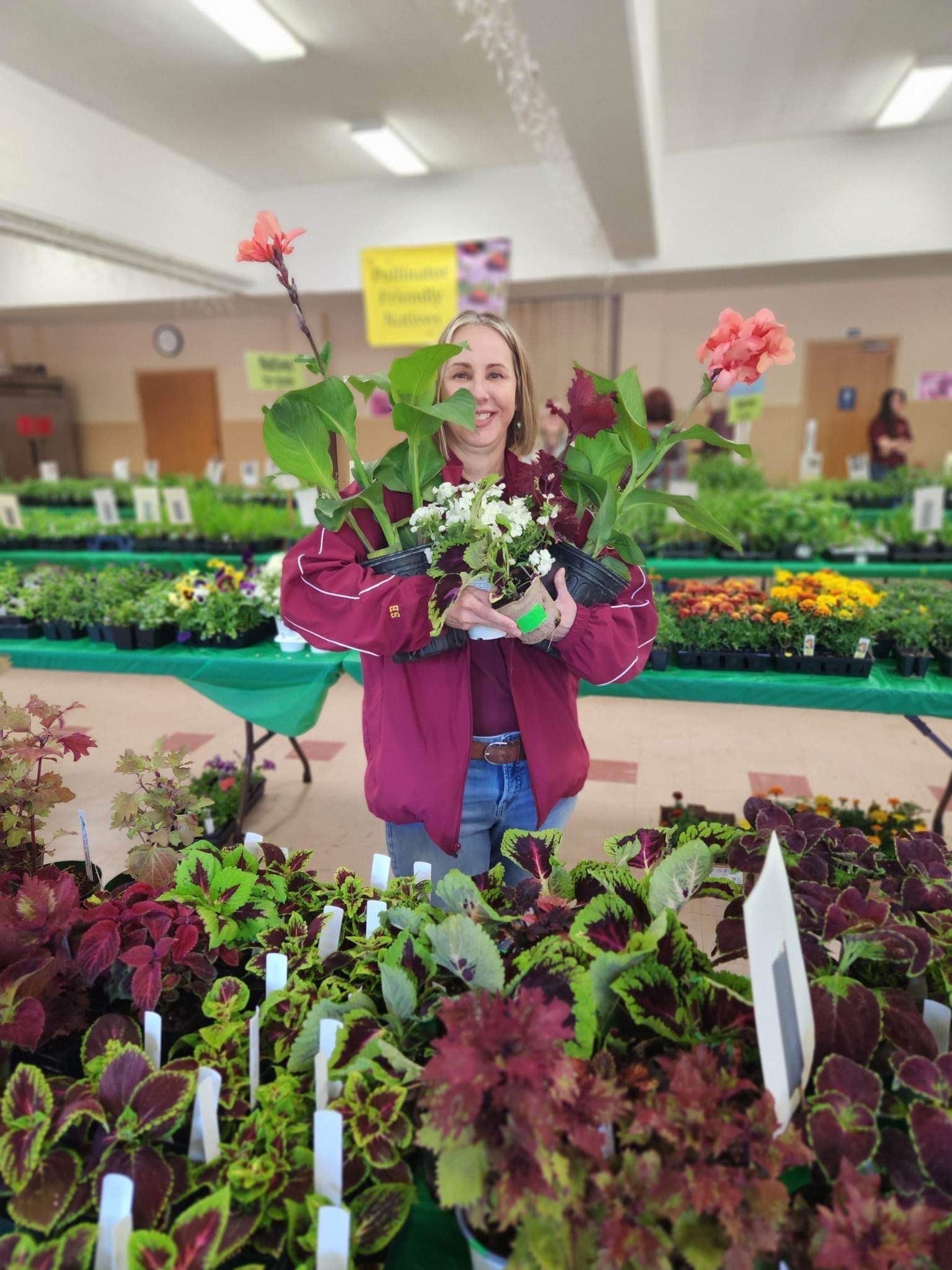 Woman holding plants at the Ramsey County Master Gardener Plant Sale.