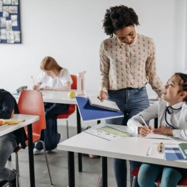 Teacher in classroom with students.