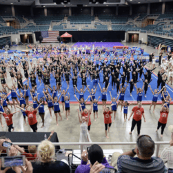 Large group of kids working on gymnastics.