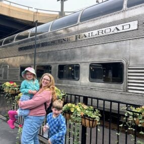 North Shore Scenic Railroad with family posing in front of train.