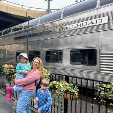 North Shore Scenic Railroad with family posing in front of train.