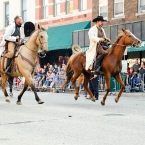 Jesse James Days actors on horses.