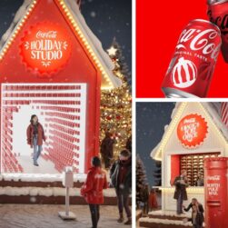 A festive scene featuring a Coca-Cola Holiday Studio with people exploring the Coca-Cola Caravan. The setup includes a red booth surrounded by Christmas lights and decorations. Two Coca-Cola cans are pictured on the right with holiday-themed designs.