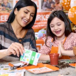 Mom and daughter building a globe planter at Home Depot event.