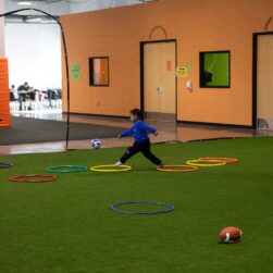 Child playing on the turf at Good Times Park Woodbury.